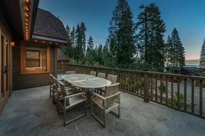 a patio with a table and chairs on a deck at Cedar Crest - Chickadee Cottage 2 in Homewood