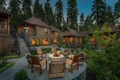 a house with a fire pit in the yard at Cedar Crest - Chickadee Cottage 2 in Homewood