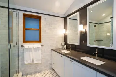 a bathroom with two sinks and a glass shower at Cedar Crest - Eagle Cottage 8 in Homewood