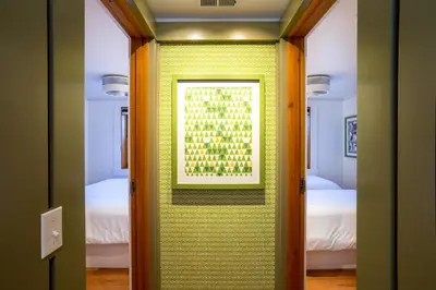 a room with a yellow wall with a picture on it at Cedar Crest - Mallard Cottage 5 in Homewood