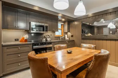 a kitchen with a wooden table and chairs at Cedar Crest - Osprey Cottage 3 in Homewood