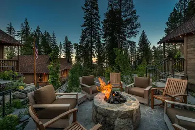 a patio with chairs and a fire pit at Cedar Crest - Osprey Cottage 3 in Homewood
