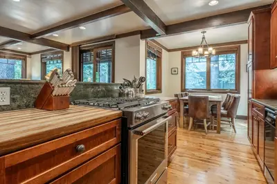 a kitchen with a stove and a dining room at Cedar Crest - Owl Cottage 9 in Homewood