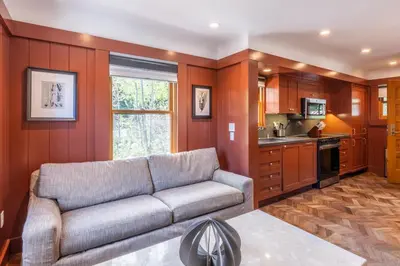 a living room with a couch and a kitchen at Cedar Crest - Robin Cottage 6 in Homewood