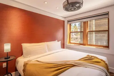 a bedroom with a bed and a window at Cedar Crest - Robin Cottage 6 in Homewood