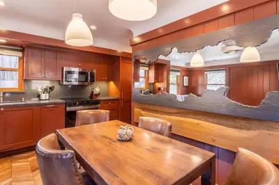 a kitchen with a wooden table and chairs at Cedar Crest - Robin Cottage 6 in Homewood