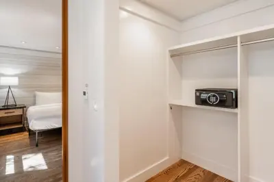 a small room with a bed and a radio on a shelf at Cedar Crest - Sparrow Cottage 1 in Homewood