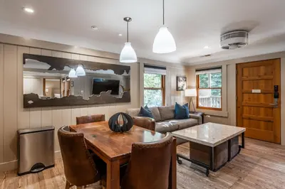 a living room with a table and a couch at Cedar Crest - Sparrow Cottage 1 in Homewood
