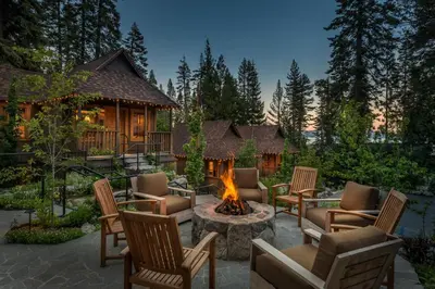 a backyard with a fire pit and chairs and a cabin at Cedar Crest - Woodpecker Cottage 7 in Homewood