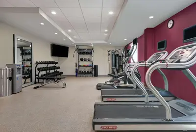 a gym with treadmills and machines in a room at Home2 Suites By Hilton Tracy, Ca in Tracy