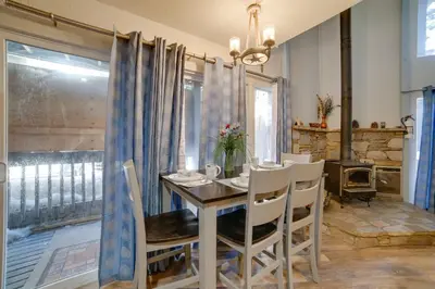a dining room with a wooden table and chairs at Resort Condo with Hot Tub and Pool, Near Ski Lift in Mammoth Lakes