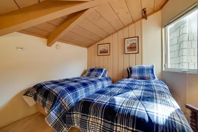 two beds in a room with a window at Resort Condo with Hot Tub and Pool, Near Ski Lift in Mammoth Lakes