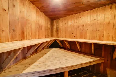 an empty wooden sauna with a bench in it at Resort Condo with Hot Tub and Pool, Near Ski Lift in Mammoth Lakes