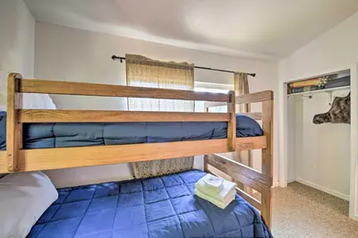 a couple of bunk beds in a room at Secluded Camp Connell Home with Deck and Fireplace! in Camp Connell