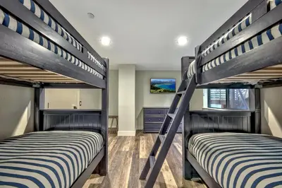 two bunk beds in a room with a bedroom at LUXE 15 Blue Diamond Lodge Lake Tahoe Hot Tub in Stateline