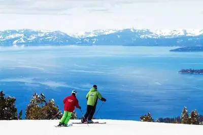 two people on skis on top of a snow covered mountain at LUXE 15 Blue Diamond Lodge Lake Tahoe Hot Tub in Stateline