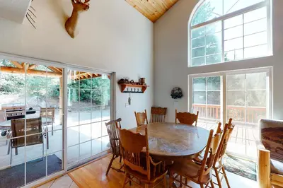 a dining room with a wooden table and chairs at Papas Mountain in Shaver Lake