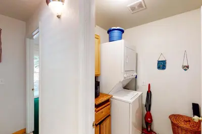 a kitchen with a white refrigerator with a blue vase on top at Papas Mountain in Shaver Lake