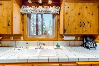 a kitchen with a sink and a window at Williams Cabin in Shaver Lake