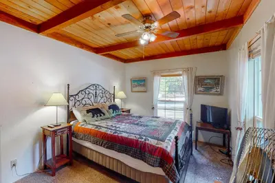 a bedroom with a bed and a ceiling fan at Maul Cabin in Shaver Lake