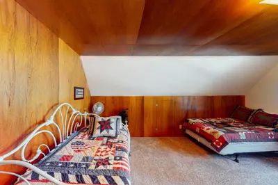 a bedroom with a bed and a couch in it at Maul Cabin in Shaver Lake