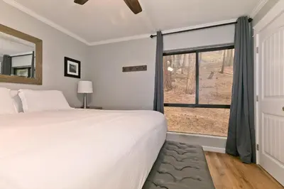 a bedroom with a large bed and a window at Bigwood 32 in Mammoth Lakes