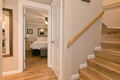 a hallway leading to a bedroom with a bed at Bigwood 32 in Mammoth Lakes