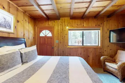 a bedroom with a bed and a couch and a window at Tahoe Delight in Tahoe City