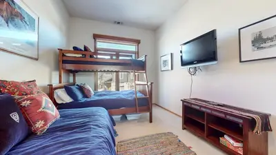 a bedroom with a bed and a bunk bed at Snowcreek #760 condo in Mammoth Lakes
