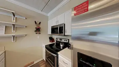 a kitchen with a stove and a microwave at Spacious 3 Bed 3 Bath Condo with Pool in Mammoth Lakes