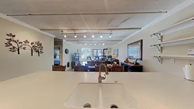 a kitchen with a sink and a living room at Spacious 3 Bed 3 Bath Condo with Pool in Mammoth Lakes
