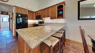 a kitchen with a large island with stools in it at Spacious 4 Bed 3 Bath Condo Great For Families! in Mammoth Lakes