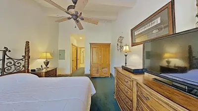 a bedroom with a bed and a flat screen tv at Spacious Two Bedroom Condo with Loft! in Mammoth Lakes