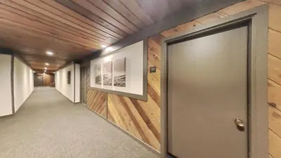 a hallway with a door and wooden walls at One Bedroom Condo Close To Canyon Lodge! in Mammoth Lakes