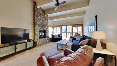 a living room with a couch and a tv at Beautifully Remodeled 4 Bedroom Home in Mammoth Lakes
