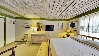 a bedroom with a bed with a wooden ceiling at Beautiful Remodeled One Bedroom Condo! in Mammoth Lakes