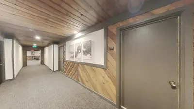 a hallway with a large door in a building at Beautiful Remodeled One Bedroom Condo! in Mammoth Lakes