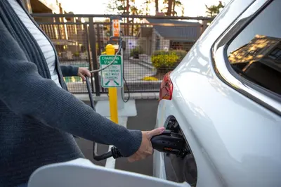 a person fueling a car at a parking meter at Beautiful Remodeled One Bedroom Condo! in Mammoth Lakes