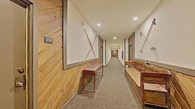a hallway with benches and a picture on the wall at Cozy One Bedroom Condo with Loft! in Mammoth Lakes