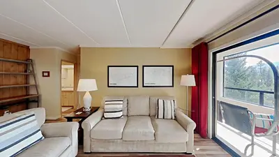 a living room with a couch and a window at Updated 2 Bdrm Condo with Shared Hot Tub in Mammoth Lakes