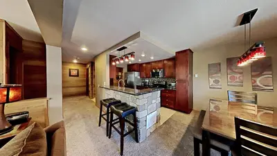 a large kitchen with a counter and a stove at Remodeled 2 Bedroom Condo withFull Kitchen! in Mammoth Lakes