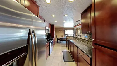 a large kitchen with a stainless steel refrigerator at Remodeled 2 Bedroom Condo withFull Kitchen! in Mammoth Lakes