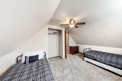 a bedroom with two beds and a ceiling fan at Pine Cone Cabin in Soda Springs