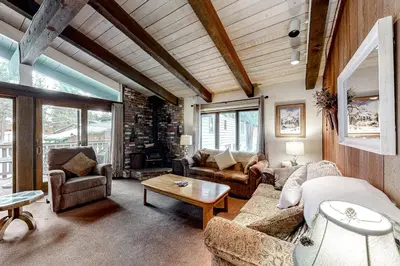 a living room with a couch and chairs and a table at Chateau Sans Nom 29 in Mammoth Lakes