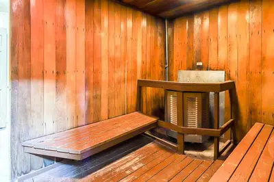 a sauna with a bench and a wooden wall at Chateau Sans Nom 29 in Mammoth Lakes