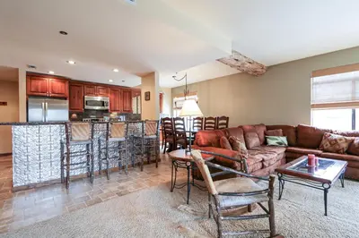 a living room with a couch and a kitchen at Silver Bear #22 condo in Mammoth Lakes
