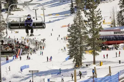a group of people on a ski lift in the snow at Delightful Northstar Condo in Kingswood Estates