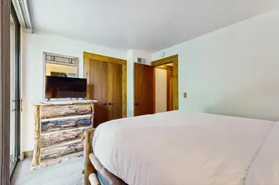 a bedroom with a bed and a flat screen tv at Delightful Northstar Condo in Kingswood Estates