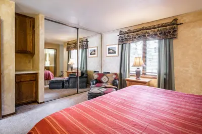 a bedroom with a large bed and a living room at Helios S # 5 in Mammoth Lakes