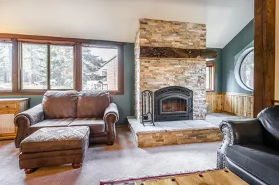 a living room with a couch and a fireplace at Helios S # 5 in Mammoth Lakes